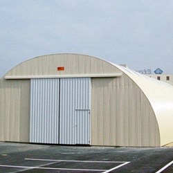 small shed with closed gate, painted in white color (ral 9003)  for maximum solar heat reflection