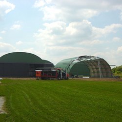 front view of hangars in construction, one XXL 6 winged door already in place