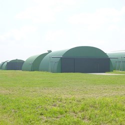 rows of round roofed airplane shelters, solar PV panels to generate electricity