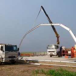 A truck crane lifts the first span and puts it in place.
