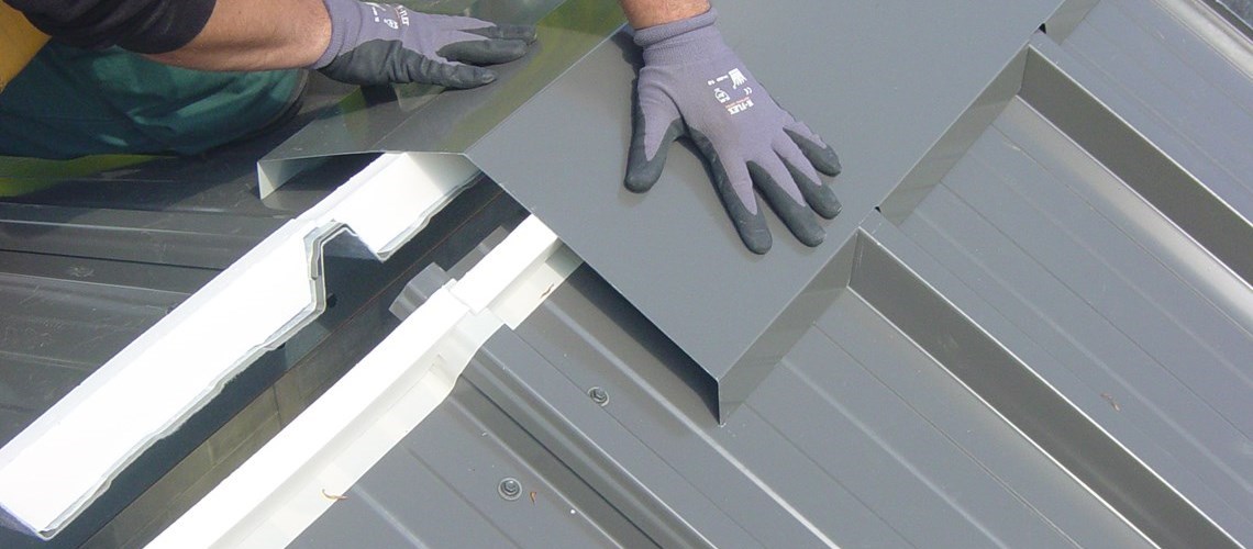 the installation of a roof ridge on a Frisomat steel building